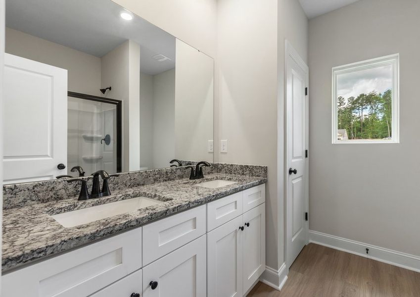 The master bathroom has a glass-enclosed shower The master bathroom has a glass-enclosed shower