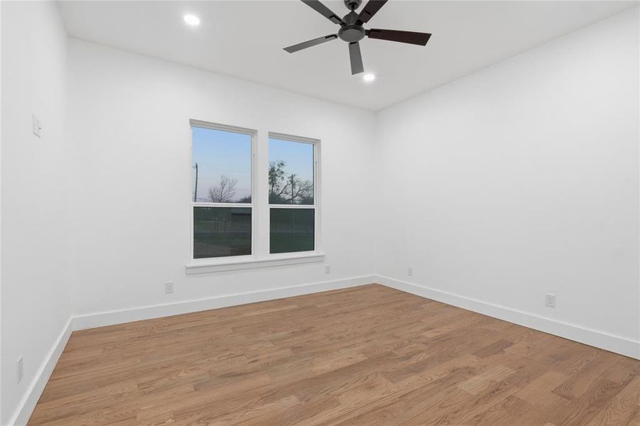 Unfurnished room featuring a ceiling fan, wood finished floors, and recessed lighting
