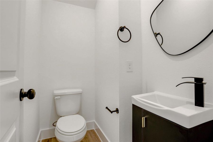 The half bath has custom fixtures, mirror, and modern wall-mounted sink.