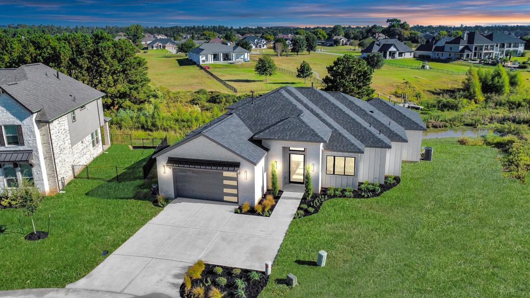 Aerial view of 299 Peninsula Point Dr highlighting a beautifully designed single-story home with upscale finishes, an expansive backyard, and serene waterfront-adjacent views with no immediate rear neighbors. Aerial view of 299 Peninsula Point Dr highlighting a beautifully designed single-story home with upscale finishes, an expansive backyard, and serene waterfront-adjacent views with no immediate rear neighbors.