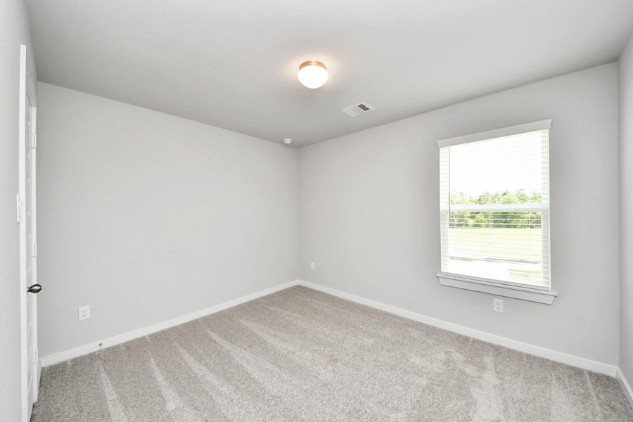 Secondary bedroom features plush carpeting, large windows that let in plenty of natural light, bright paint, and spacious closets. Secondary bedroom features plush carpeting, large windows that let in plenty of natural light, bright paint, and spacious closets.