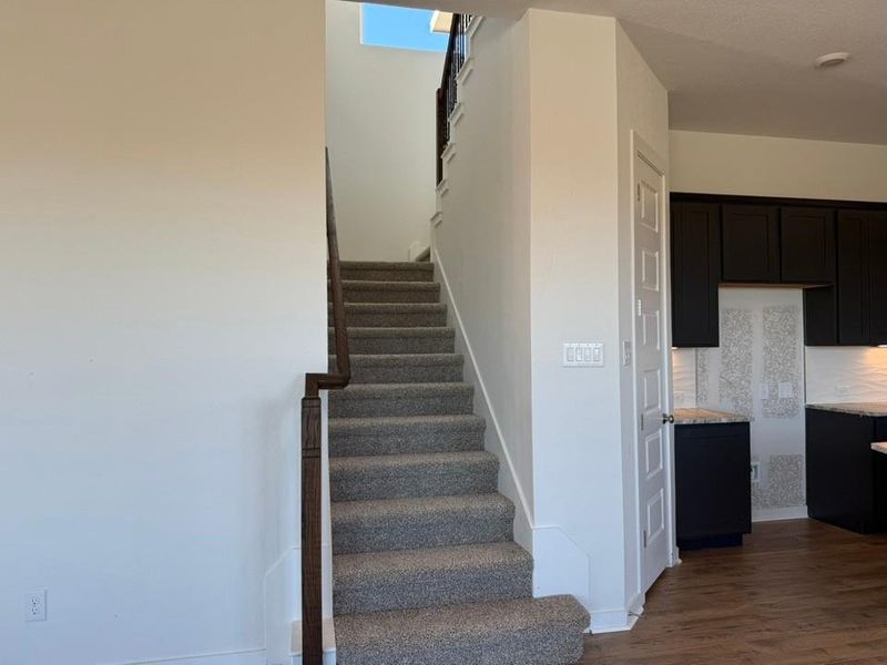 Stairway featuring wood finished floors and baseboards Stairway featuring wood finished floors and baseboards