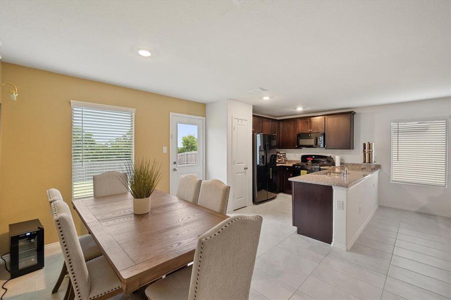 Dining area with light tile patterned flooring, healthy amount of natural light, and recessed lighting
