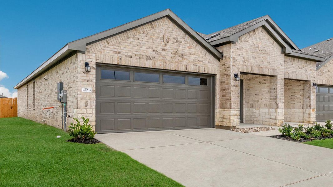 Front exterior of a new home in Palomino, Manor, TX, highlighting curb appeal (Image 1). Front exterior of a new home in Palomino, Manor, TX, highlighting curb appeal (Image 1).