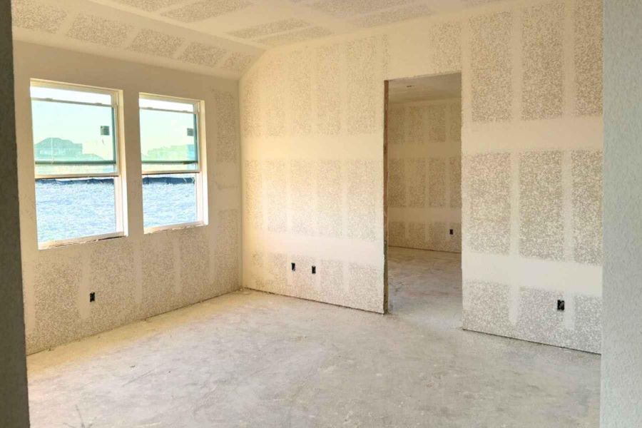 Unfurnished room featuring vaulted ceiling
