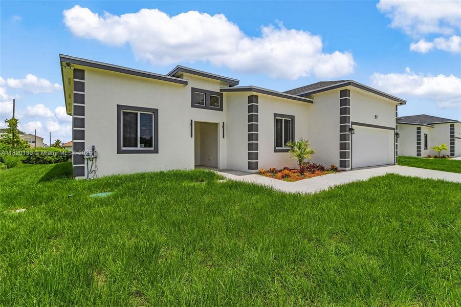 Front exterior of a new home in , Lehigh Acres, FL, highlighting curb appeal (Image 15).