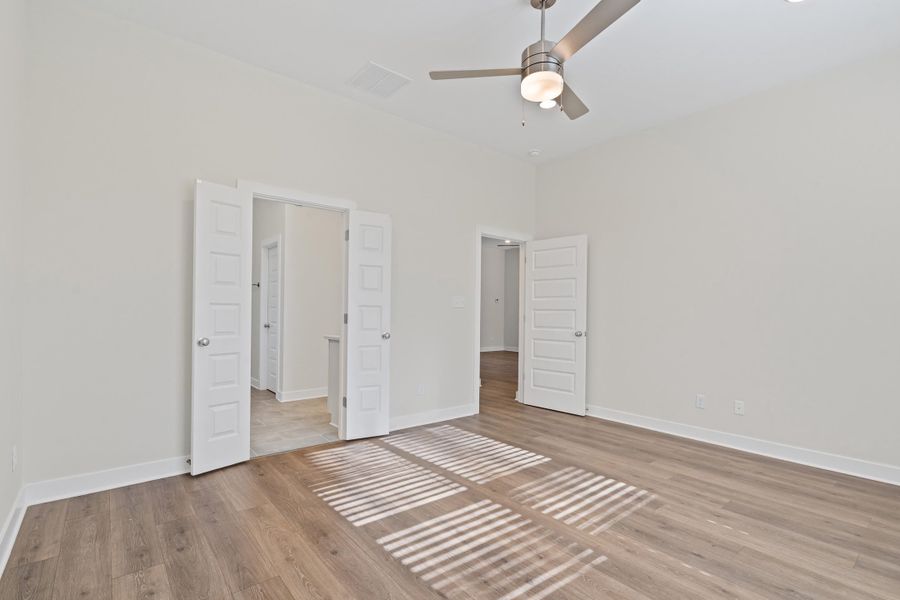 Unfurnished bedroom with light wood-style floors and ceiling fan