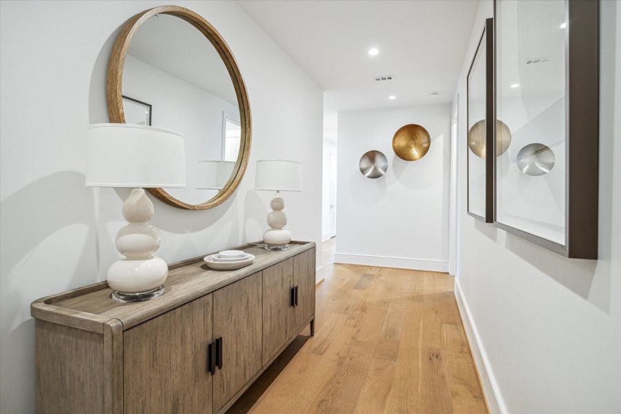 Featuring wide-plank hardwood floors and soaring ceilings, the entryway sets the tone for the home’s Modern style. Photos are of a similar unit with the same floor plan Featuring wide-plank hardwood floors and soaring ceilings, the entryway sets the tone for the home’s Modern style. Photos are of a similar unit with the same floor plan