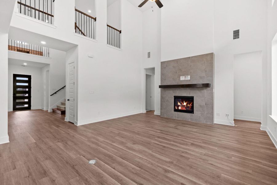 Family Room with soaring ceiling & fireplace