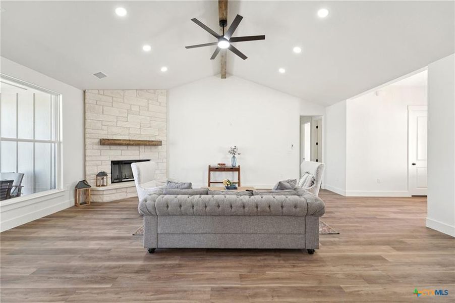 Vast vaulted ceilings complement the wood flooring and stone fireplace in this elegant living area. Vast vaulted ceilings complement the wood flooring and stone fireplace in this elegant living area.