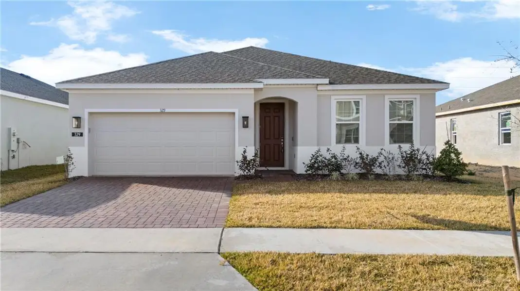 Front exterior of a new home in , Haines City, FL, highlighting curb appeal (Image 1). Front exterior of a new home in , Haines City, FL, highlighting curb appeal (Image 1).