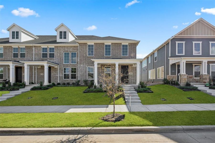 Lovey brick with classic white trim creates wonderful curb appeal for this dream home!