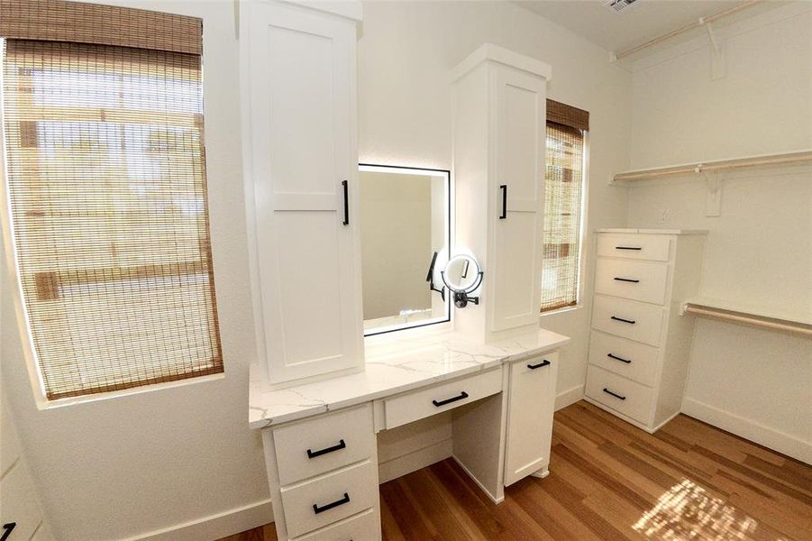 Oversized closet with makeup vanity and plenty of natural light.