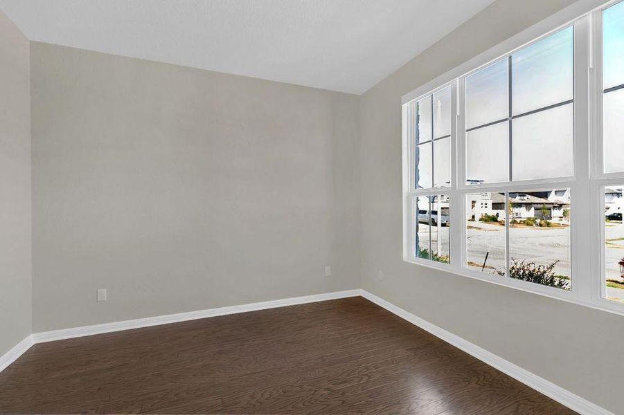 Unfurnished room featuring dark wood finished floors and a residential view Unfurnished room featuring dark wood finished floors and a residential view