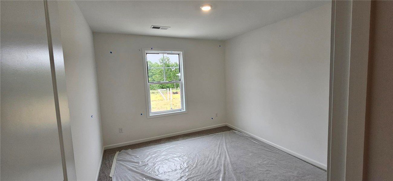 This spacious room features a large window and sof