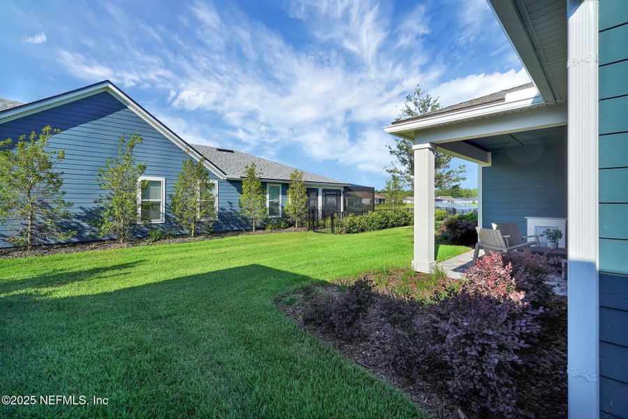 Front exterior of a new home in Summer Bay at Grand Oaks, St. Augustine, FL, highlighting curb appeal (Image 19). Front exterior of a new home in Summer Bay at Grand Oaks, St. Augustine, FL, highlighting curb appeal (Image 19).