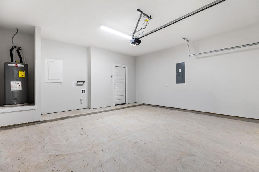 A spacious, newly finished garage offers ample storage and direct home access.