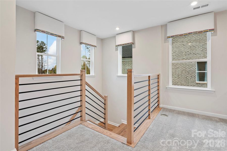 Modern open rail opens up the loft space to light and flow.