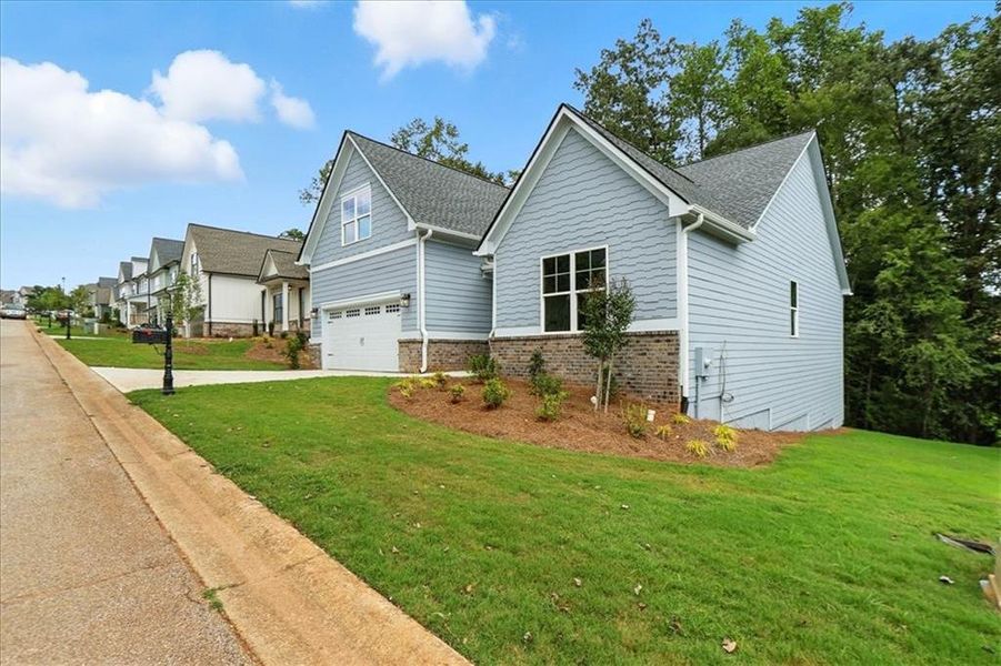 Front exterior of a new home in Traditions of Braselton, Jefferson, GA, highlighting curb appeal (Image 26). Front exterior of a new home in Traditions of Braselton, Jefferson, GA, highlighting curb appeal (Image 26).