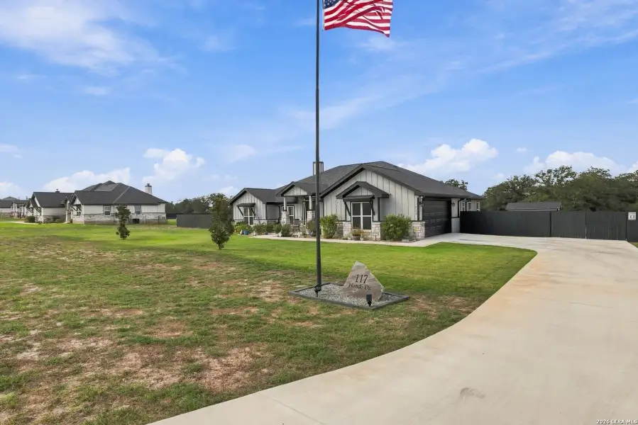 Front exterior of a new home in , La Vernia, TX, highlighting curb appeal (Image 2). Front exterior of a new home in , La Vernia, TX, highlighting curb appeal (Image 2).