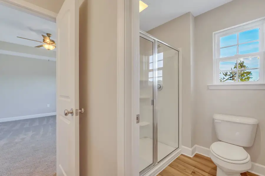 Rose Atoll - Owner's Bath shower and water closet | Ernest Homes