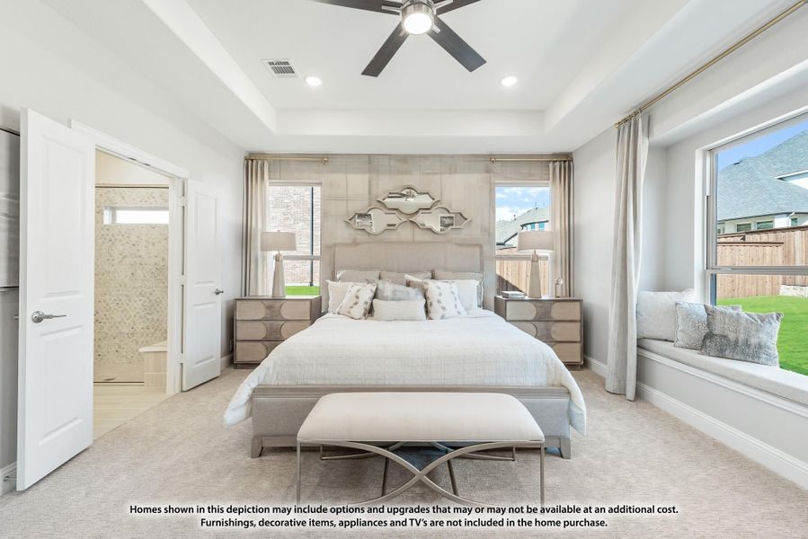 Master bedroom with tray ceiling, ceiling fan, window seat, and ensuite bathroom access Master bedroom with tray ceiling, ceiling fan, window seat, and ensuite bathroom access