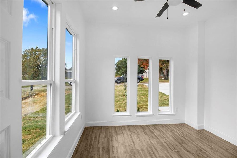 Spare room with wood finished floors, recessed lighting, and ceiling fan Spare room with wood finished floors, recessed lighting, and ceiling fan