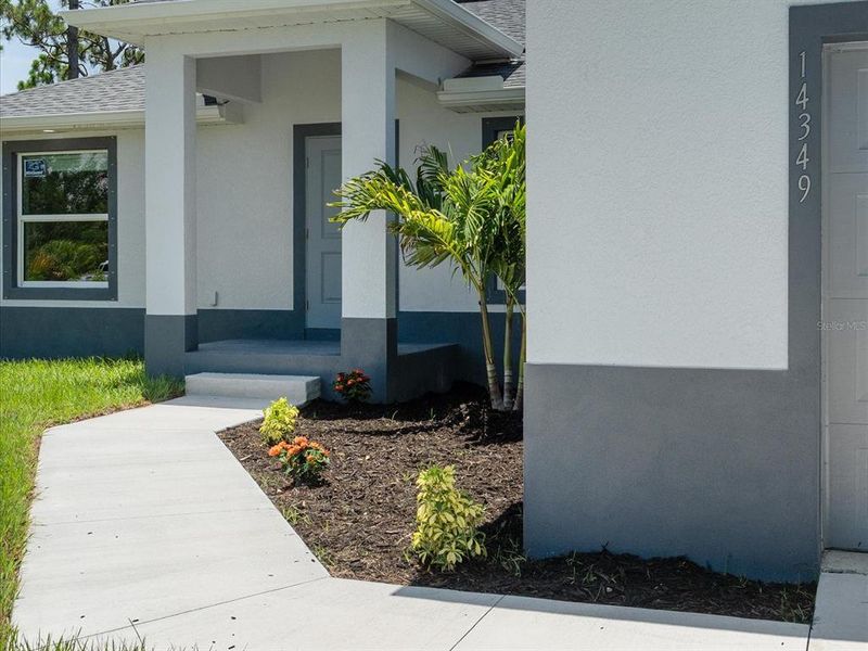 Front exterior of a new home in , Port Charlotte, FL, highlighting curb appeal (Image 2).
