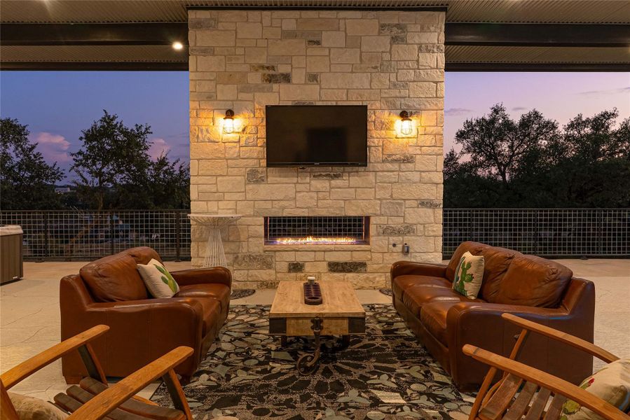 Outdoor fireplace and gathering spaces bring lake living to life.