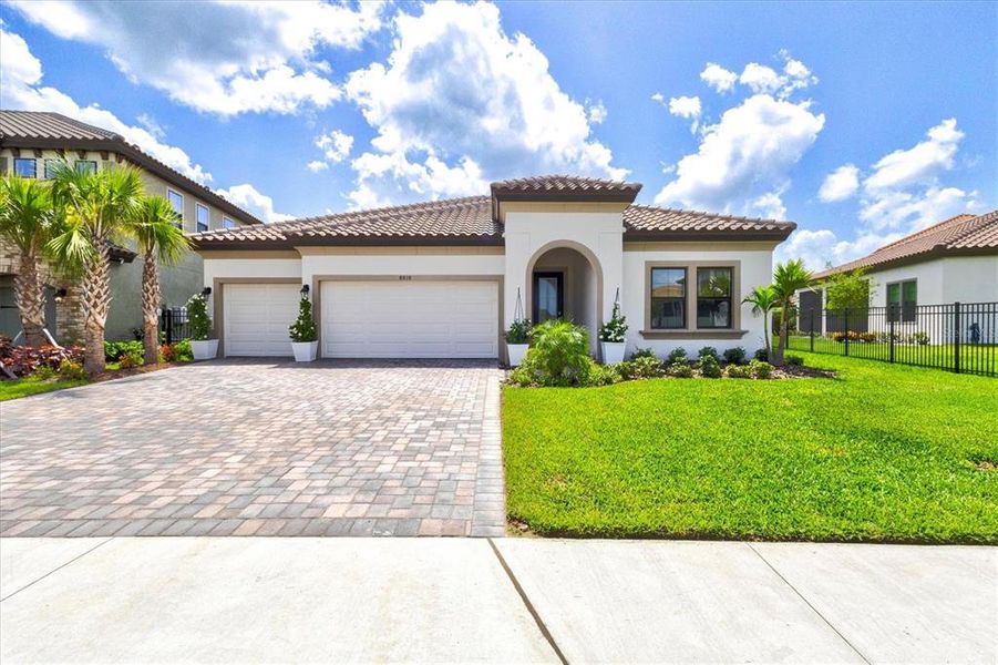 Front exterior of a new home in Crosswind Ranch, Parrish, FL, highlighting curb appeal (Image 26).