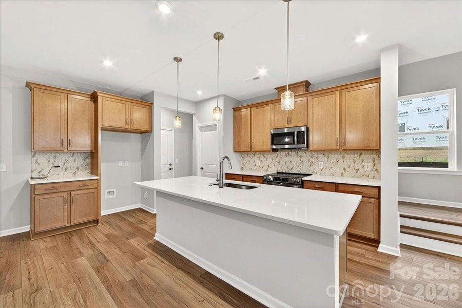 Chef-inspired kitchen with warm brown cabinets Chef-inspired kitchen with warm brown cabinets