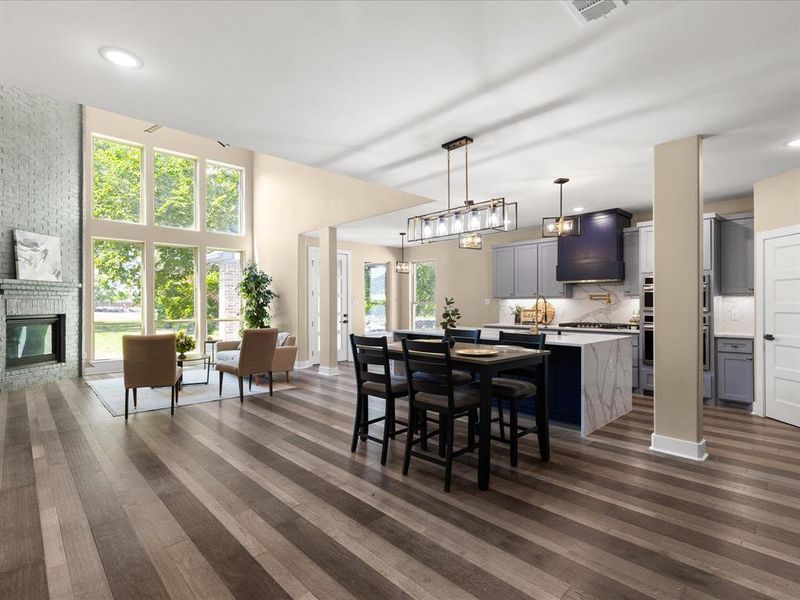 Dining area featuring recessed lighting, dark wood-style flooring, and a fireplace