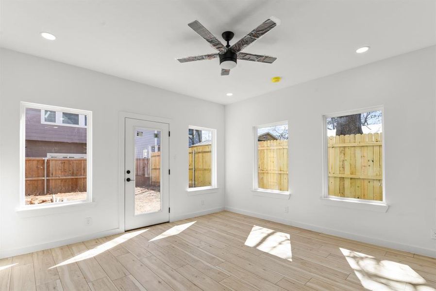 Living room featuring a ceiling fan, baseboards, wood finished floors, and recessed lighting