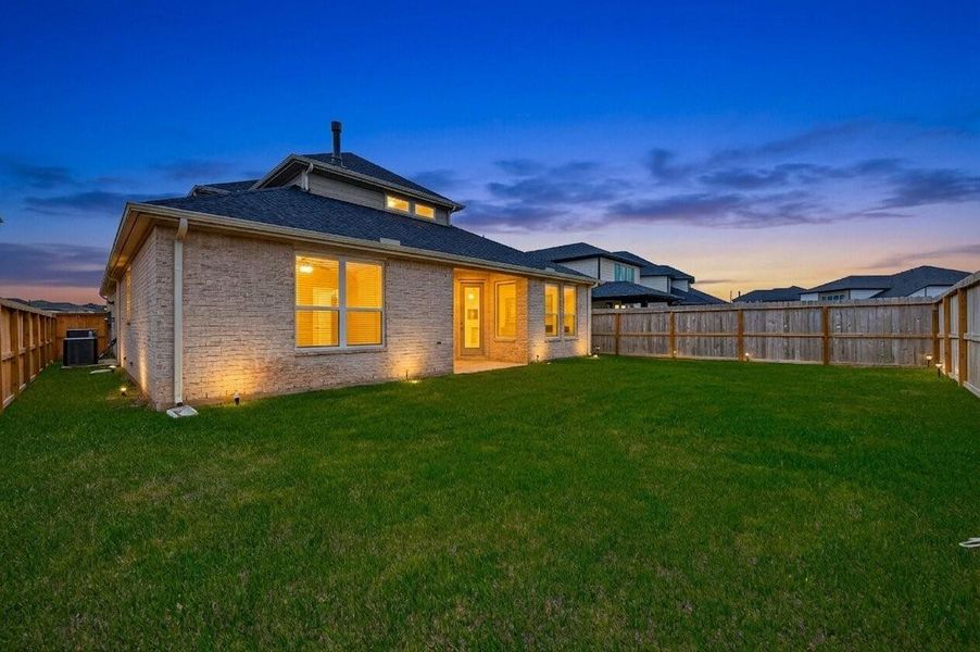 Twilight photo: Home is complete with a two-car garage with remote opener, sprinkler system, rain gutters, and a backyard patio with a gas stub—perfect for outdoor grilling! Plenty of room for entertaining and outdoor activities!