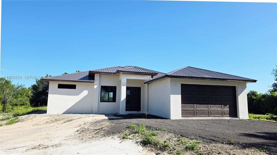 Front exterior of a new home in , Clewiston, FL, highlighting curb appeal (Image 5).