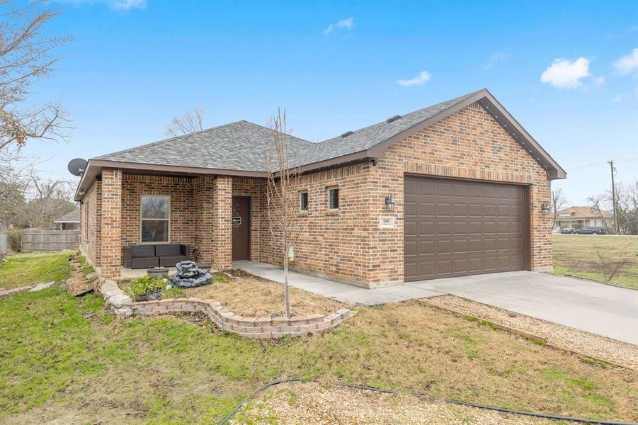 Ranch-style house with a garage and a front yard