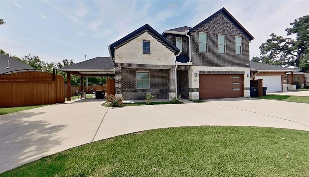 View of front of house featuring concrete driveway, brick siding, and a garage