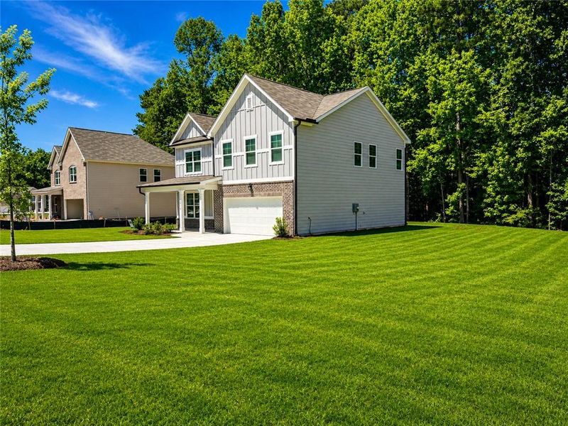 Front exterior of a new home in Whisper Creek, Atlanta, GA, highlighting curb appeal (Image 21). Front exterior of a new home in Whisper Creek, Atlanta, GA, highlighting curb appeal (Image 21).