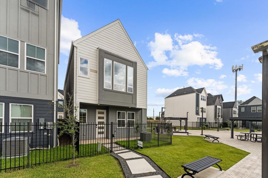 This thoughtfully designed two-story residence features a unique layout that places the living room, kitchen, and dining area on the second floor, creating a bright and airy space ideal for entertaining. Expansive windows flood the open-concept floor with natural light, while sleek finishes and modern fixtures add a touch of sophistication.