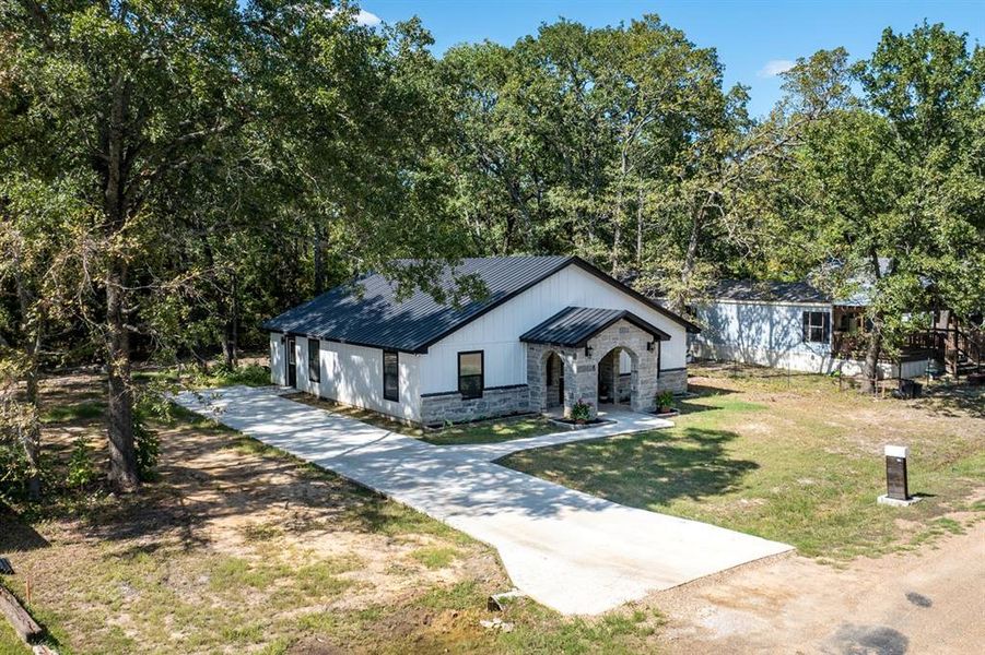 Modern farmhouse style home featuring a front lawn