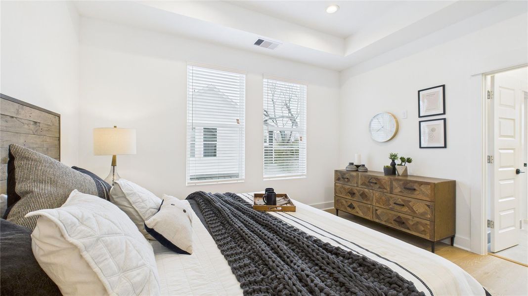 Bright and spacious, this spacious primary bedroom is filled with natural light and features two generous closets, his and hers, along with a well-sized primary bathroom, creating a bright and comfortable retreat with ample storage and luxury.
