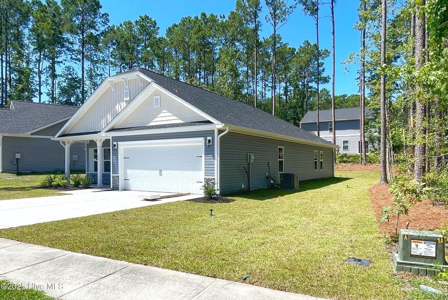 Front exterior of a new home in Mill Creek Cove, Bolivia, NC, highlighting curb appeal (Image 17). Front exterior of a new home in Mill Creek Cove, Bolivia, NC, highlighting curb appeal (Image 17).