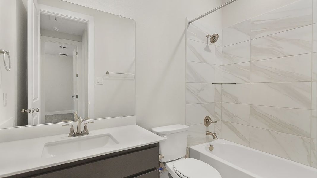Representative furnished interior of a home built from the Brenner by Chesmar Homes in Newhaven, Manor (Image 6).