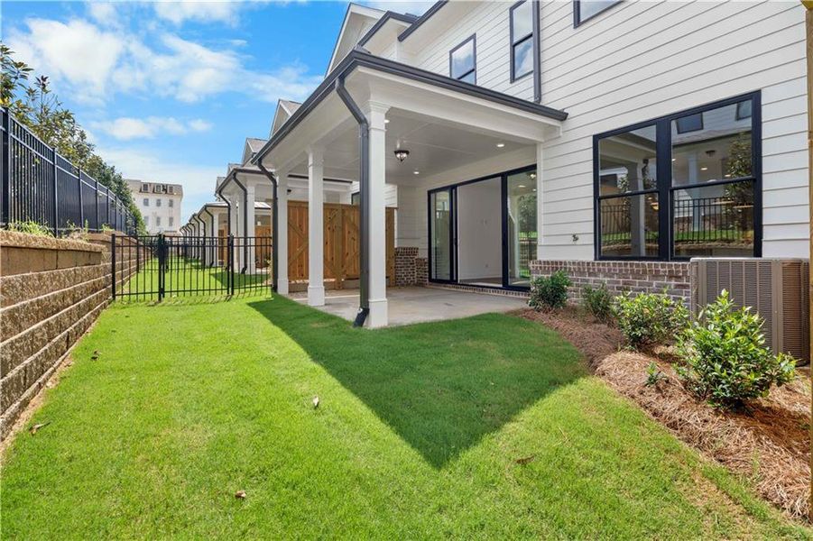 Exterior details and patio area of a home in Millcroft Townhomes, Buford (Image 26).