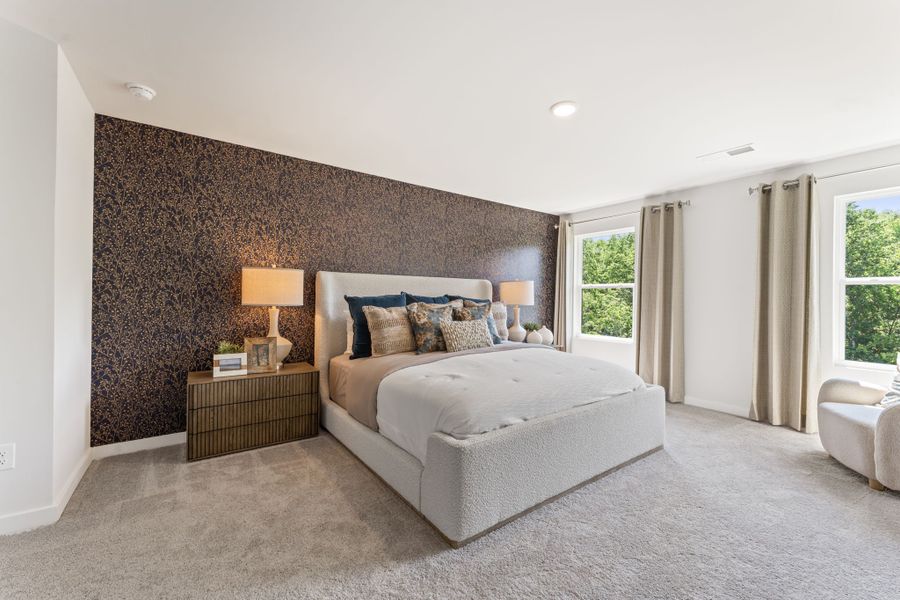 A bedroom with a bed and a couch. A bedroom with a bed and a couch.