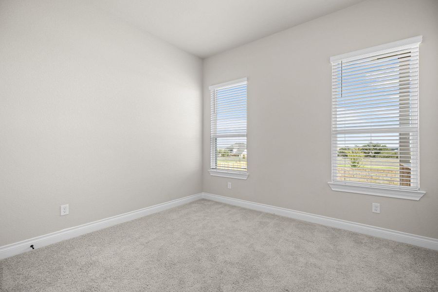 Spare room featuring light carpet and baseboards