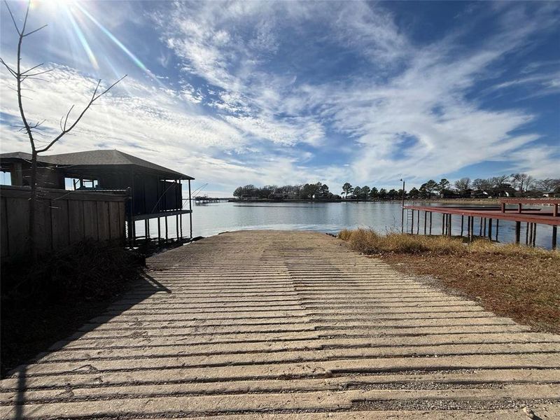 Dock area featuring a boat ramp and a water view