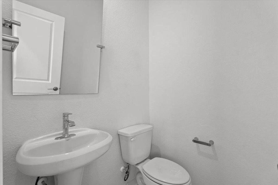 A well-appointed half-bath with contemporary fixtures offers everyday convenience.