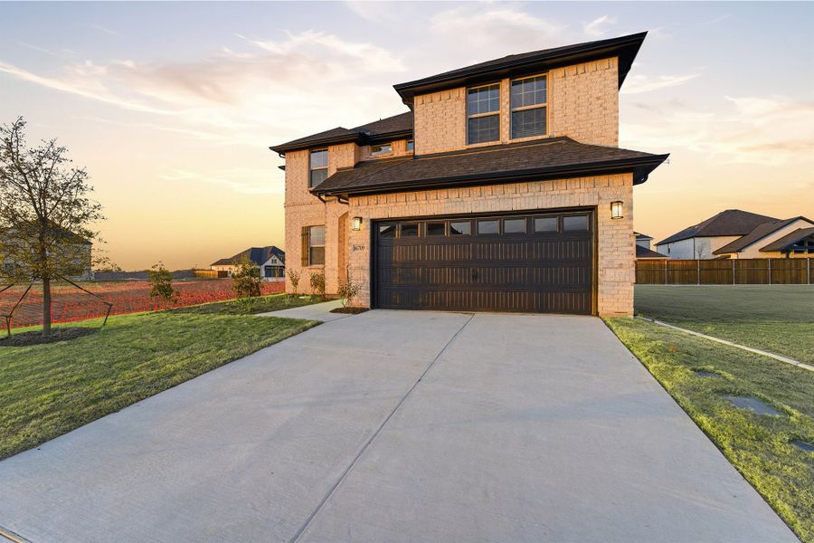 Front exterior of a new home in Green Meadows, Celina, TX, highlighting curb appeal (Image 26). Front exterior of a new home in Green Meadows, Celina, TX, highlighting curb appeal (Image 26).