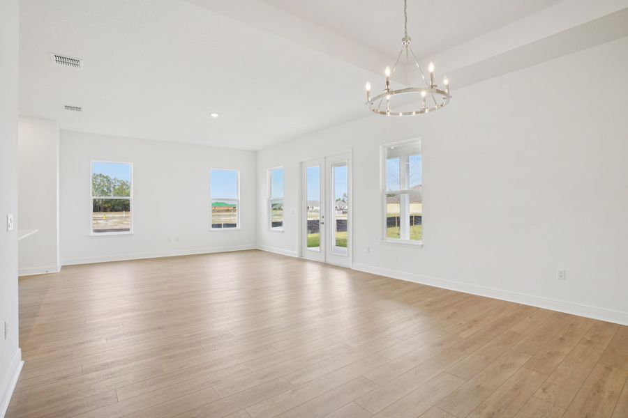 Representative unfurnished interior of a home built from the Siesta II by Ashton Woods in Ardisia Park, New Smyrna Beach (Image 8).